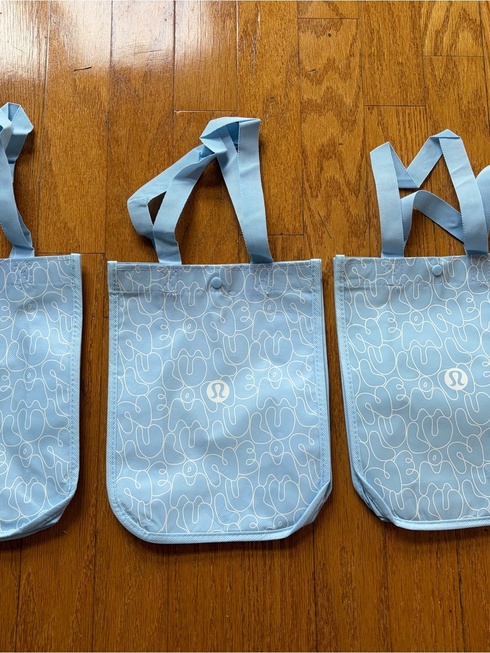 New, set of 3 lululemon small Light Blue Tote, White Swirl Logo. Hard to find!